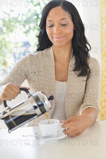 Woman pouring coffee.