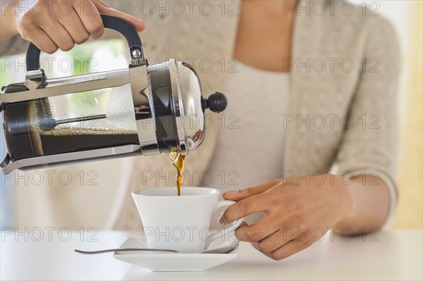 Woman pouring coffee.