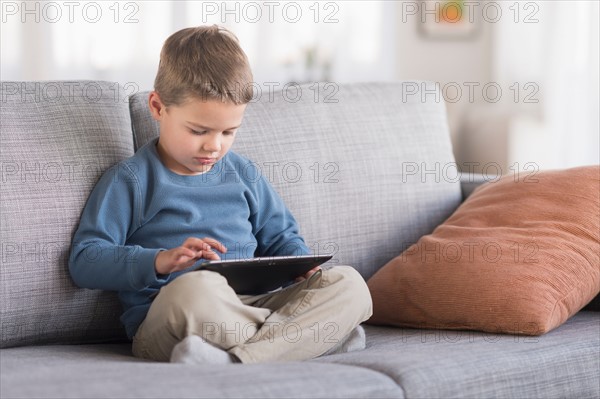 Boy (4-5) using tablet pc.