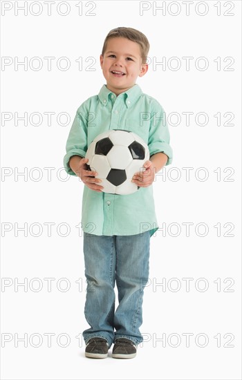 Portrait of boy (4-5) holding soccer ball.