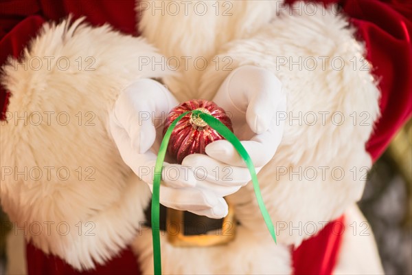 Santa claus holding gift.