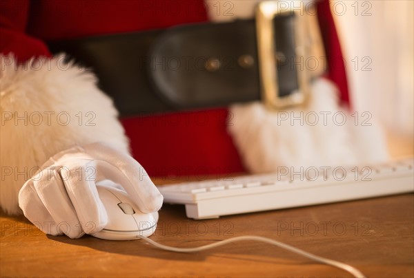 Close-up of santa claus using computer.