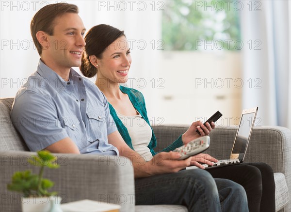 Couple watching tv together.