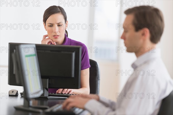 Office workers using computers.