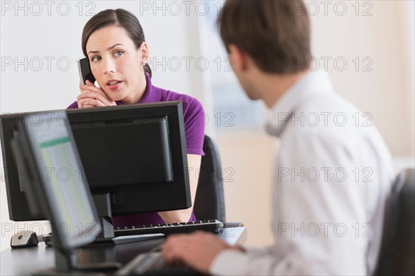 Office workers using computers.