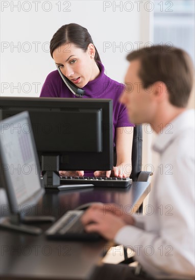 Office workers using computers.