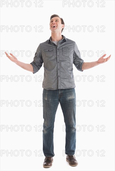 Young man looking up and gesturing.