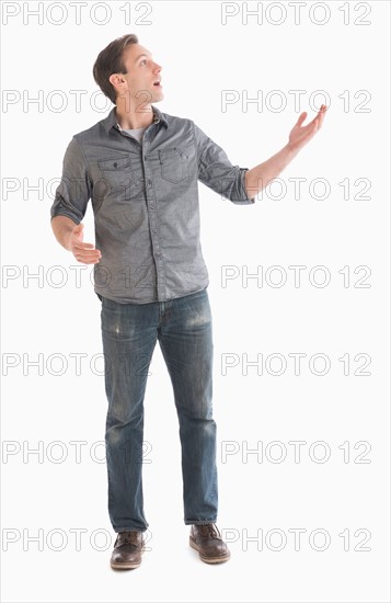 Young man looking up and gesturing.