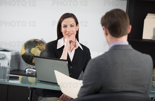 Businesswoman talking to businessman.