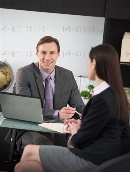 Businessman talking to businesswoman.