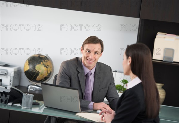 Businessman talking to businesswoman.