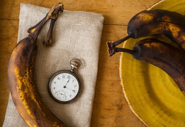 Still life with bananas and pocket watch.