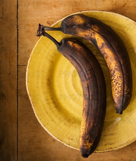 Still life with rotting bananas .