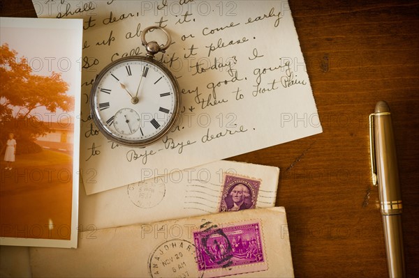 Still life with pocket watch, old letter and photograph.