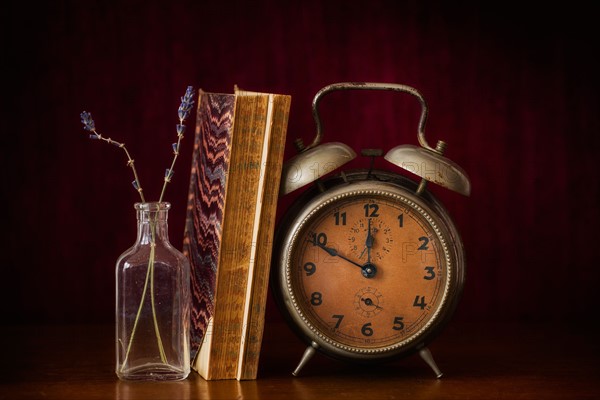 Still life with antique clock and books.