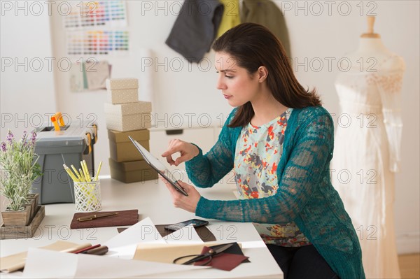 Fashion designer using digital tablet.