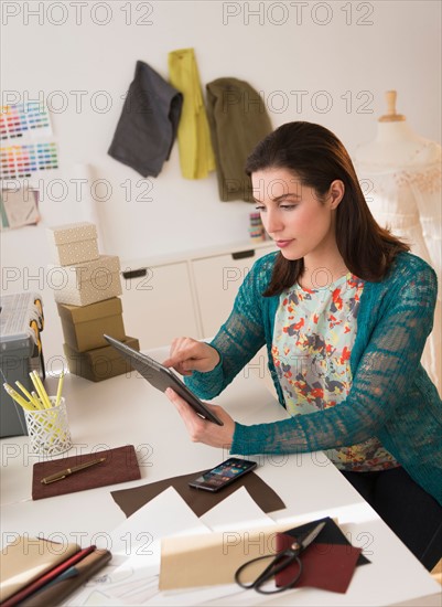 Fashion designer using digital tablet.