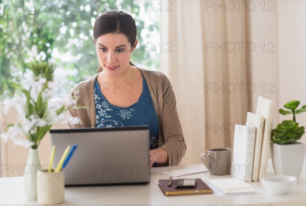 Woman working on laptop.