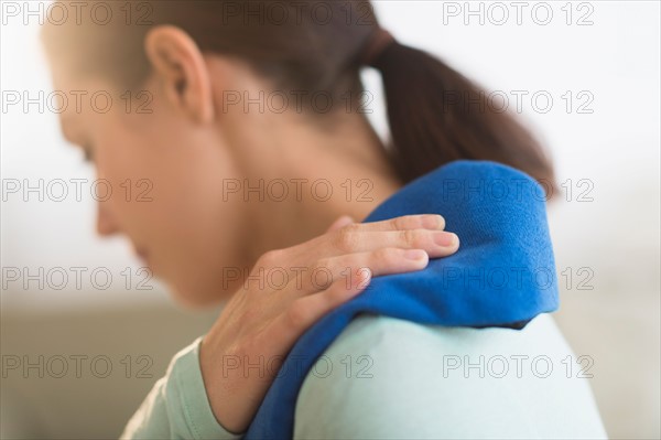 Woman touching aching back.