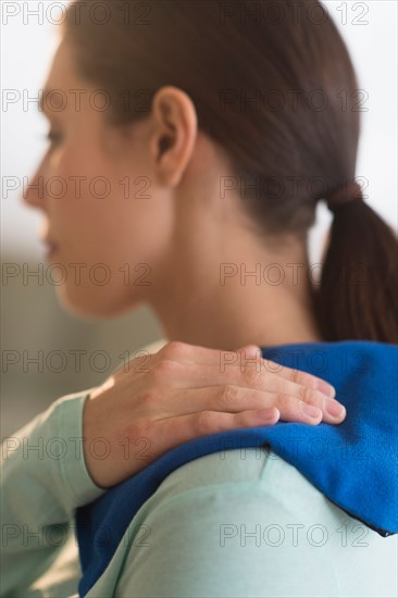 Woman touching aching back.