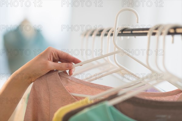 Woman choosing blouse.