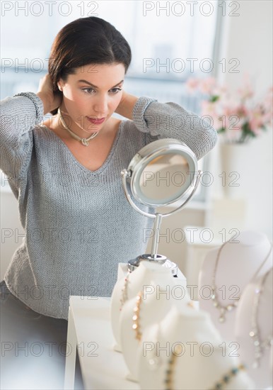 Woman trying on necklace.