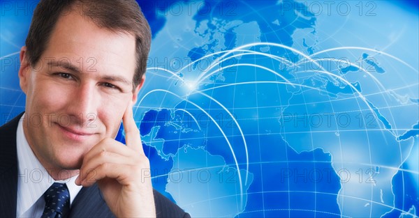Portrait of businessman with world map in background.
