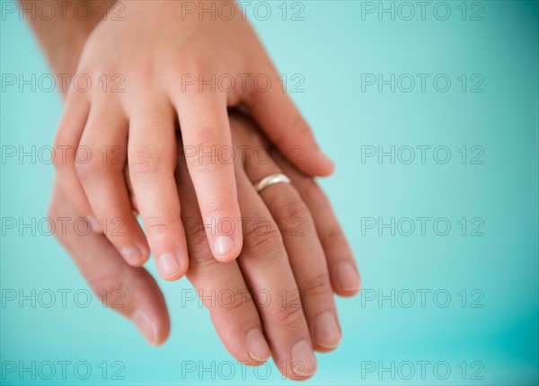 Son (8-9) holding father's hand