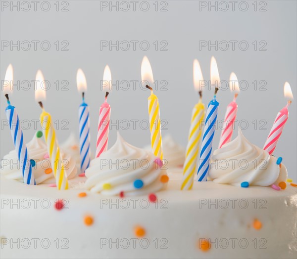 Studio shot of birthday cake with lit candles