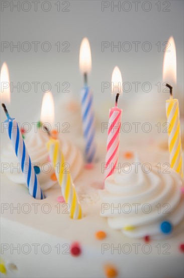 Studio shot of birthday cake with lit candles