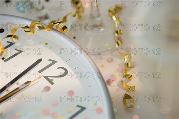 12 o'clock on clock decorated with confetti and streamer