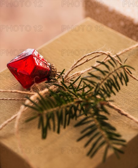 Christmas gift decorated with pine leaf and bauble