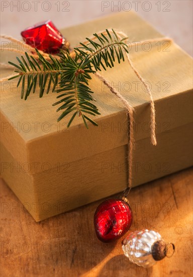 Christmas gift decorated with pine leaf and bauble