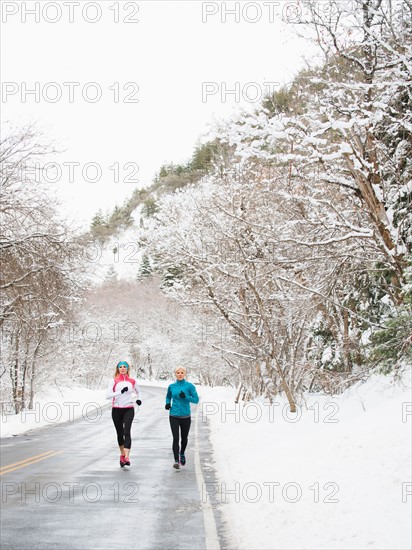 Two women jogging in winter