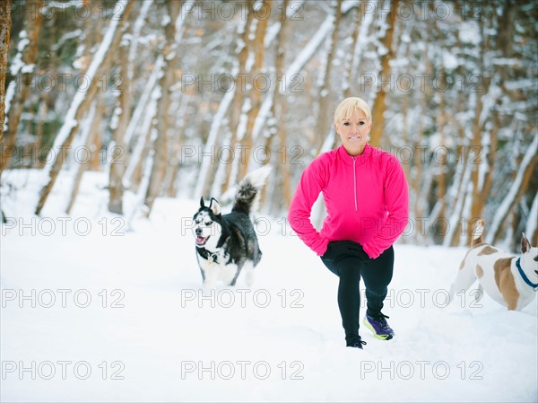 Woman exercising in winter forest