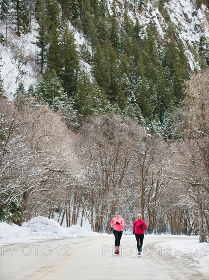 Two women jogging in winter