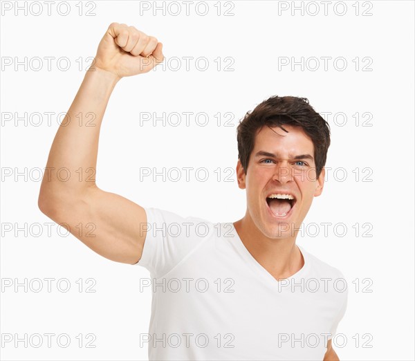 Studio portrait of handsome man cheering