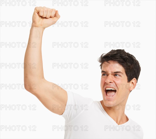 Studio portrait of handsome man cheering