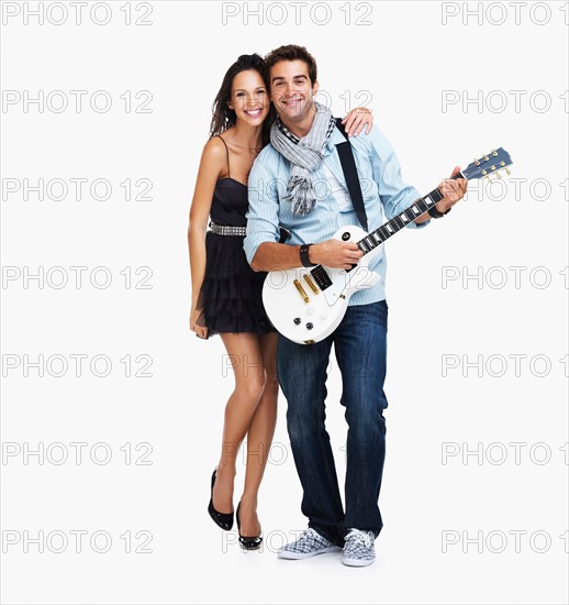 Studio portrait of male guitarist with fan