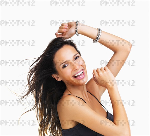 Studio Shot, Portrait of smiling young woman with raised arms