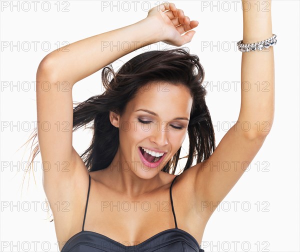 Studio Shot, Portrait of young woman with arms raised