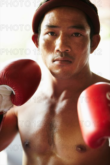 Portrait of mid adult male boxer in fighting stance