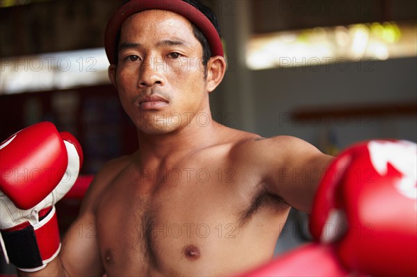 Portrait of mid adult male boxer in fighting stance