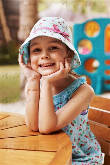 Portrait of smiling girl (6-7) sitting at table