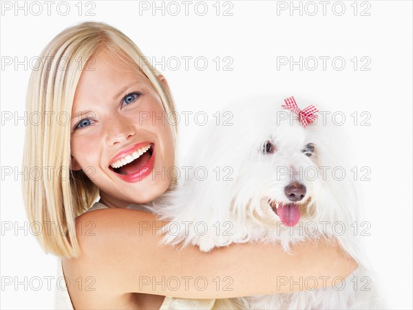 Studio Shot, Portrait of young woman holding dog