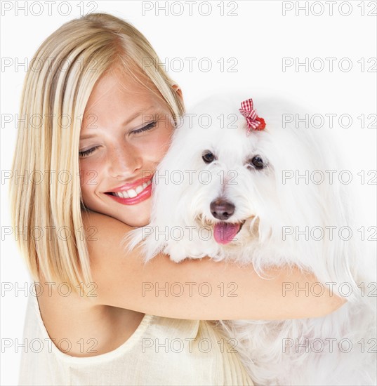 Studio Shot, Portrait of young woman holding dog