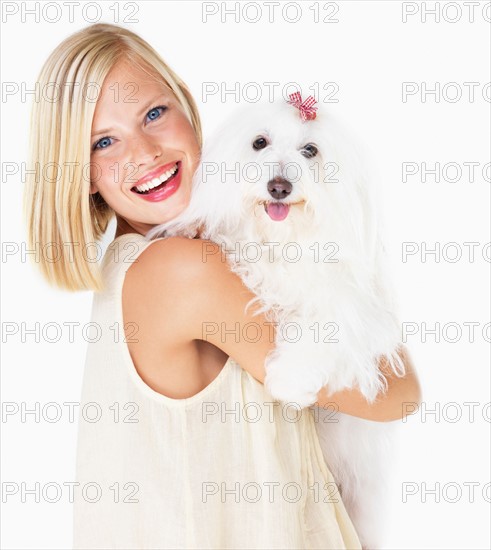 Studio Shot, Portrait of young woman holding dog