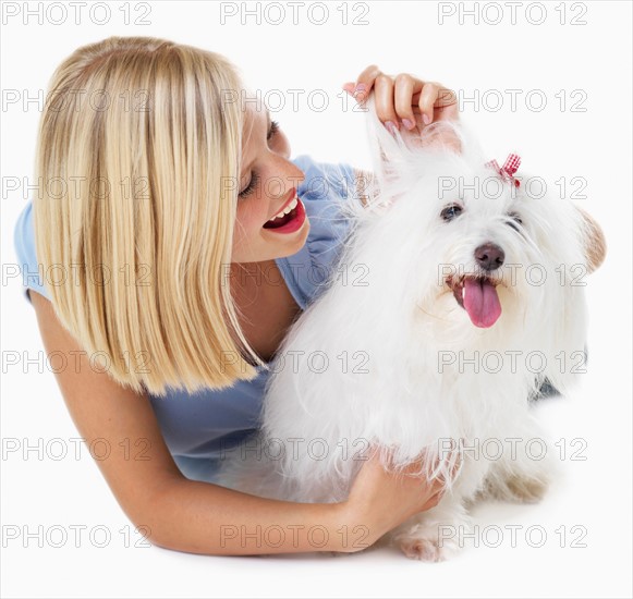 Studio Shot, Portrait of young woman stroking her dog