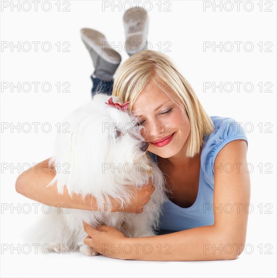 Studio Shot, Portrait of young woman hugging her dog