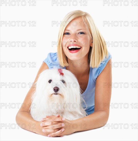 Studio Shot, Portrait of smiling young woman lying down with her dog
